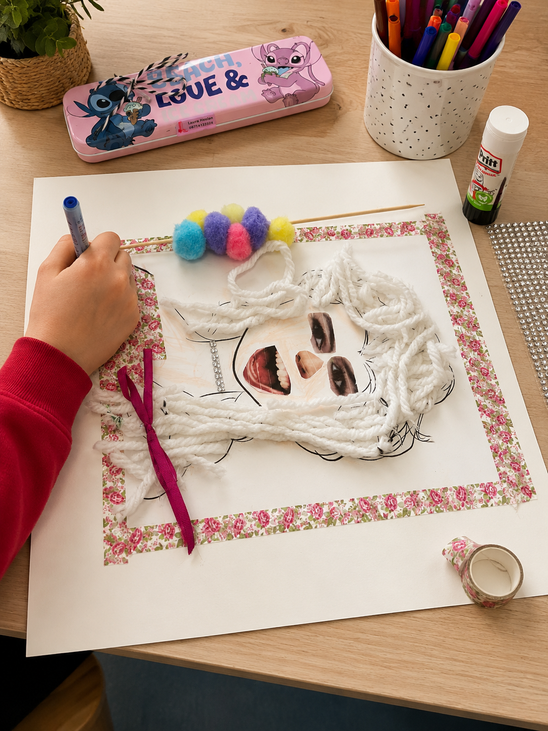 Female figure with white yarn hair on patterned paper